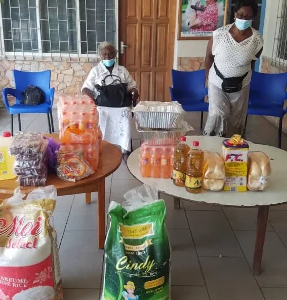 Golden Youth Foundation representative standing with a program beneficiary during a community visit.